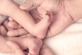 Newborn baby feet in mother hands with love Royalty Free Stock Photo