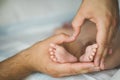 Newborn baby feet in mother hands. Royalty Free Stock Photo