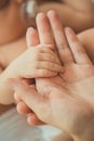 Newborn baby feet in mother hands. Royalty Free Stock Photo