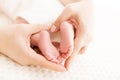 Newborn Baby Feet in Mother Hands, Mom massaging New Born Kid Foot Royalty Free Stock Photo