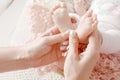 Newborn baby feet in mother hands. Mother holding legs of the kid in hands. Close up image. Royalty Free Stock Photo