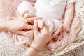 Newborn baby feet in mother hands. Mother holding legs of the kid in hands. Close up image. Happy family concept Royalty Free Stock Photo