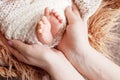 Newborn baby feet in mother hands. Mother holding legs of the kid in hands. Close up image. Happy family concept Royalty Free Stock Photo
