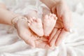 Newborn baby feet in mother hands, shape like a lovely heart. Mother holding legs of the kid in hands. Close up image. Happy Royalty Free Stock Photo