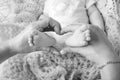 Newborn baby feet in mother hands, shape like a lovely heart. Mother holding legs of the kid in hands. Close up image. Happy Royalty Free Stock Photo