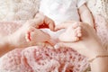 Newborn baby feet in mother hands, shape like a lovely heart. Mother holding legs of the kid in hands. Close up image. Happy Royalty Free Stock Photo