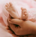 Newborn baby feet in mother's hand,closeup shot Royalty Free Stock Photo