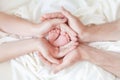 Newborn baby feet in white cloth wrapped in heart, baby life Royalty Free Stock Photo