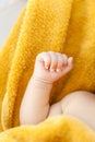 Newborn baby fist on yellow towel, summer pool time, babyhood concept