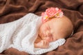 Newborn baby with flower sleeping