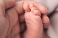 Newborn baby foot in mother hand