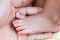 newborn baby foot on parents hand