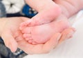 Newborn baby foots in mothers hands