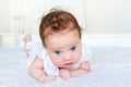 Newborn baby girl with big blue eyes on her tummy Royalty Free Stock Photo