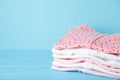 Newborn baby girl clothes on blue background, top view Royalty Free Stock Photo