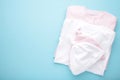 Newborn baby girl clothes on blue background, top view Royalty Free Stock Photo