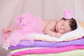 Newborn baby girl in a crown sleeping on the bed of mattresses. Fairy Princess and the Pea Royalty Free Stock Photo