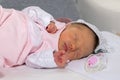 Newborn baby girl dressed in a pink sleep suit. The baby girl is 15 days old Royalty Free Stock Photo