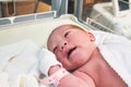 Newborn baby girl just born in hospital in the maternity ward with a plastic tag on her wrist Royalty Free Stock Photo