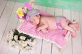 Newborn baby girl in a knitted hare costume sleeping on a wooden crib birch Royalty Free Stock Photo