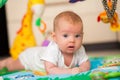 Newborn baby lying on a play mat