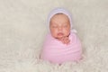 Newborn Baby Girl with Pink Bonnet and Swaddle