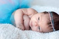 Newborn baby girl. Portrait of a newborn girl with a fluffy skirt and the pink - blue Headbands with beads. Royalty Free Stock Photo