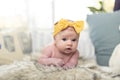 Newborn baby girl posing with a twinkle in her eyes. Royalty Free Stock Photo