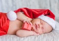 Newborn baby girl in red santa hat sleeping with a gift Royalty Free Stock Photo