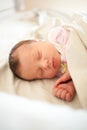 Newborn baby girl sleeping in bed Royalty Free Stock Photo