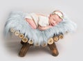 Newborn baby girl sleeps on small wooden crib. Royalty Free Stock Photo