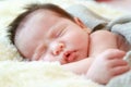 Newborn baby girl smiling in a dream ,Newborn baby girl is sleep Royalty Free Stock Photo