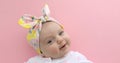 Newborn baby girl smiling pink background Royalty Free Stock Photo
