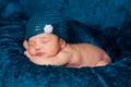 Newborn Baby Girl Wearing a Teal Flapper Style Hat Royalty Free Stock Photo