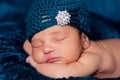 Newborn Baby Girl Wearing a Teal Flapper Style Hat Royalty Free Stock Photo