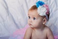 Newborn baby girl wearing a white crocheted crown, ballerina tutu, and ballet slippers. She is sleeping on pink rose Royalty Free Stock Photo