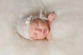 Newborn Baby Girl Wearing a White Knitted Bonnet Royalty Free Stock Photo