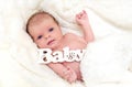 Newborn baby girl on white fluffy coverlet