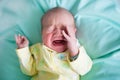 Newborn baby on a green blanket