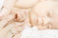 Newborn baby hand holding parent finger. Close up. Royalty Free Stock Photo