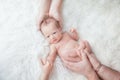 A newborn baby in the hands of parents of mom and dad and the elder child is holding his hand on a white background Royalty Free Stock Photo