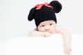 Newborn baby with hat on the head lying on blanket.