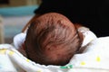 newborn baby head and hair for on white diaper