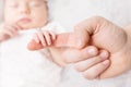 Newborn Baby Holding Mother Hand, Mom Finger and New Born Kid on White Royalty Free Stock Photo