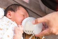 Newborn baby infant eating milk from bottle. Royalty Free Stock Photo