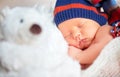 Newborn baby in knit cap and teddy toy bear sleeping Royalty Free Stock Photo