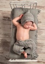 Newborn baby in knitted hat and pants sleeping Royalty Free Stock Photo