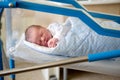 Newborn baby laying in crib in prenatal hospital Royalty Free Stock Photo