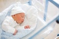 Newborn baby laying in crib in prenatal hospital Royalty Free Stock Photo