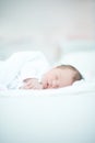 Newborn Baby Laying on White Bed Royalty Free Stock Photo